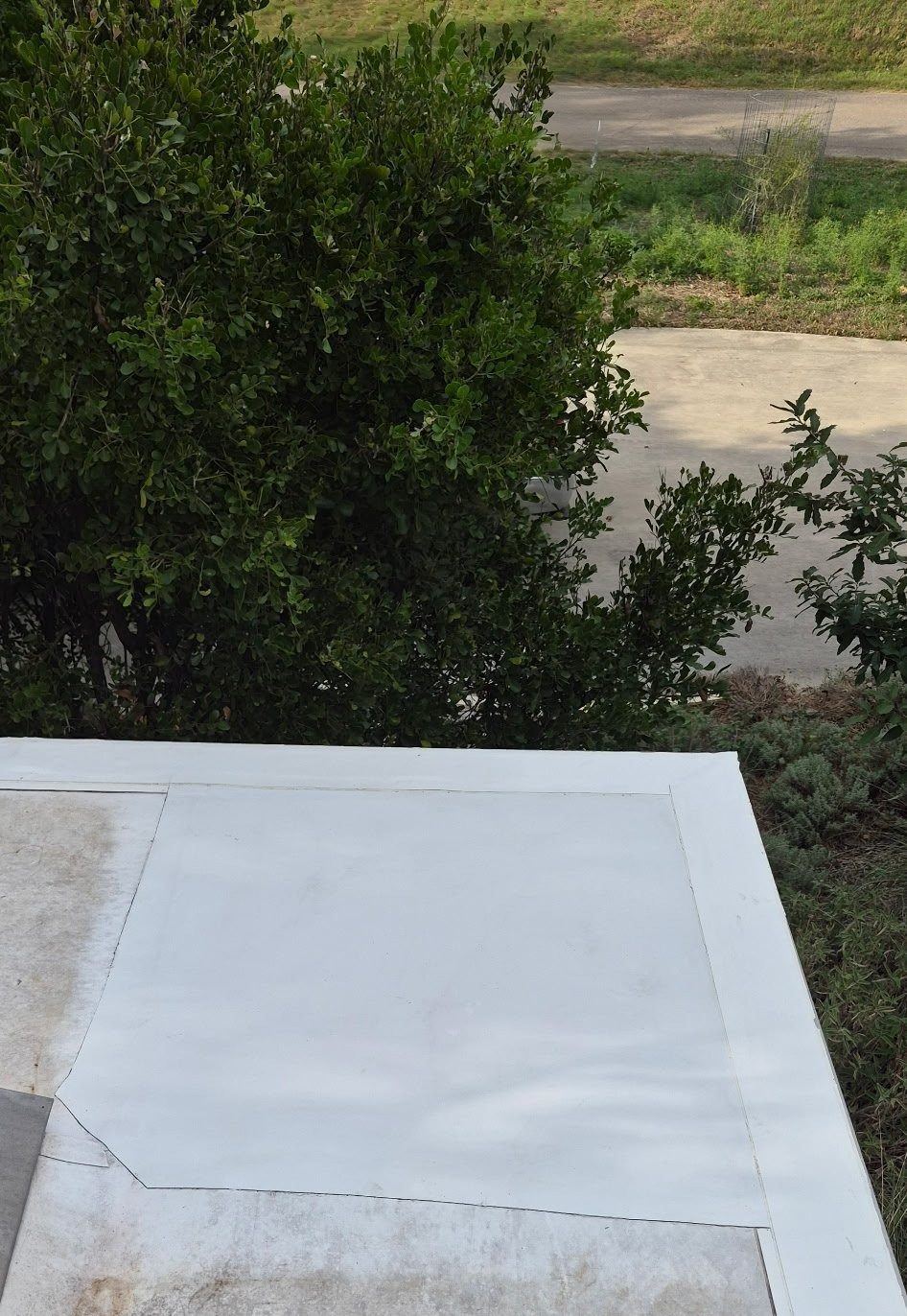 New white TPO membrane installed over a repaired roof corner by RAM Roofing